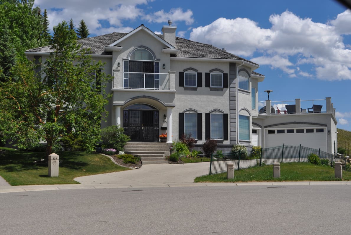 A large two-story suburban house with a well-kept lawn.